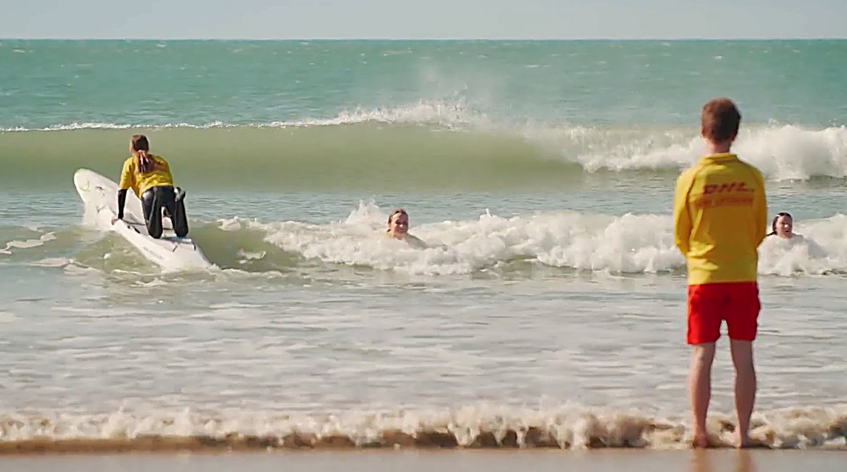 Nippers and lifeguards in the shorebreak, the local surf club keeping an eye on a busy summer beach, Kaka Pt surf spot, Catli